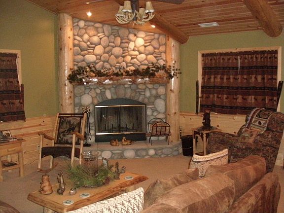 River rock fireplace is living room focal point
