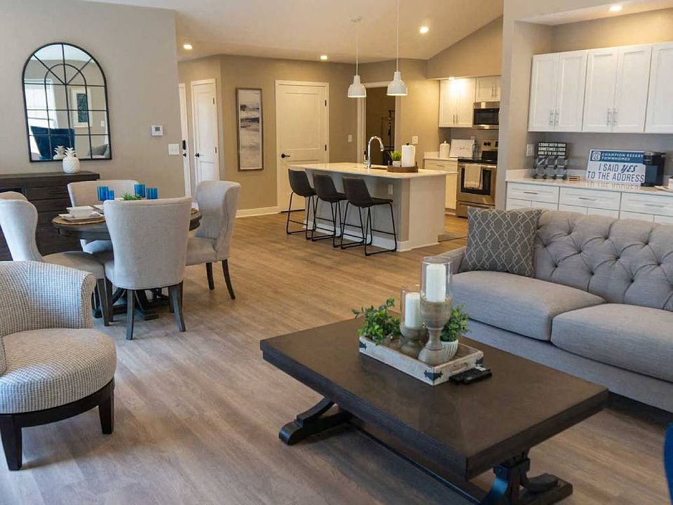 Interior of Champion Reserve Townhome Great Room showing living area, dining area, coffee bar, and kitchen area with breakfast bar.
