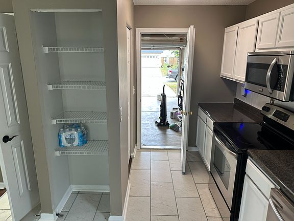 View of kitchen, pantry, and door leading out to the garage