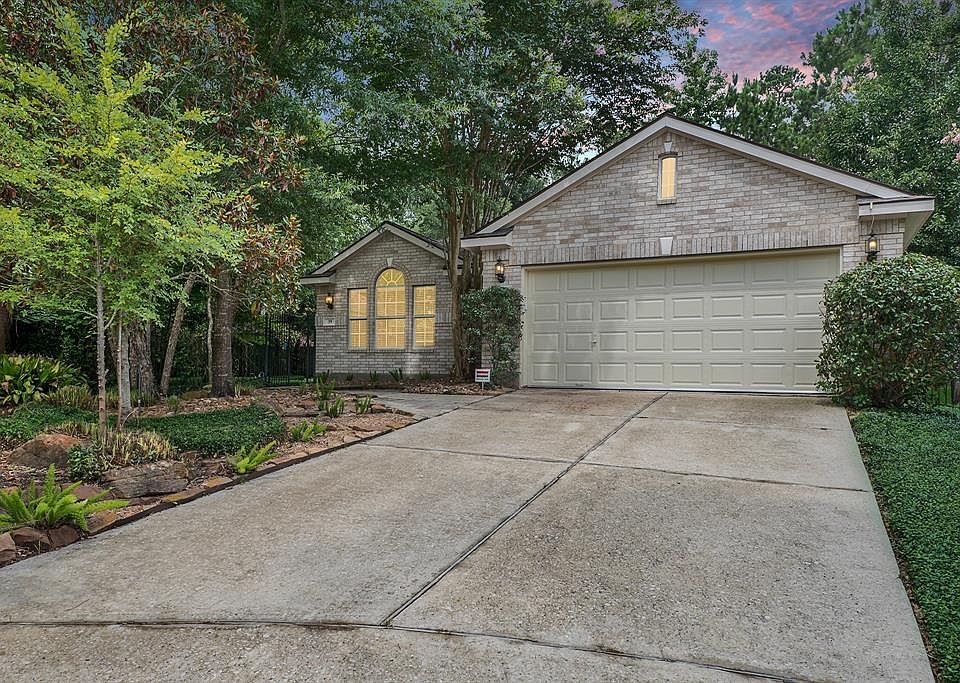 Tucked in the trees on a true cul de sac lot, this courtyard home offers forested views from almost every window & little-to-no lawn maintenance