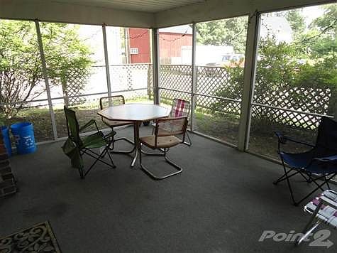 Nice screened porch is used by the lower level tenants.