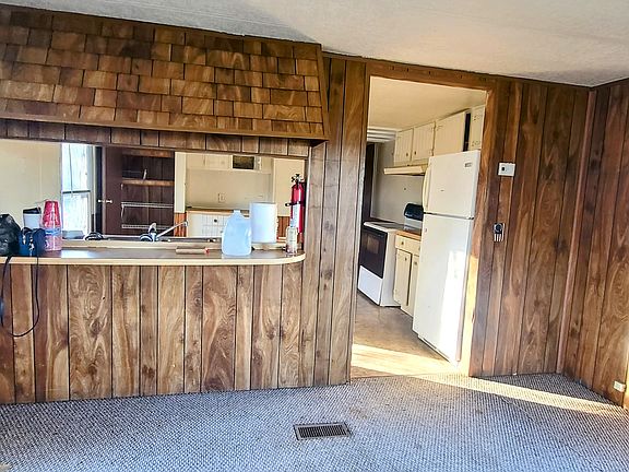 Front living room faces a breakfast nook and opens into kitchen area.