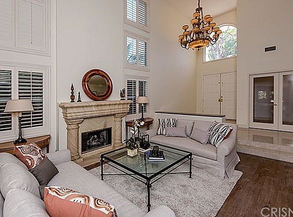 Living room with fireplace, new stressed flooring, plantation shutters and a room for future wine cellar,