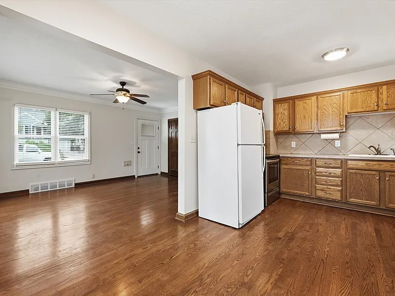 View of kitchen. Solid oak cabinetry, tile backsplash. GFCI outlets. Under cabinet lighting.