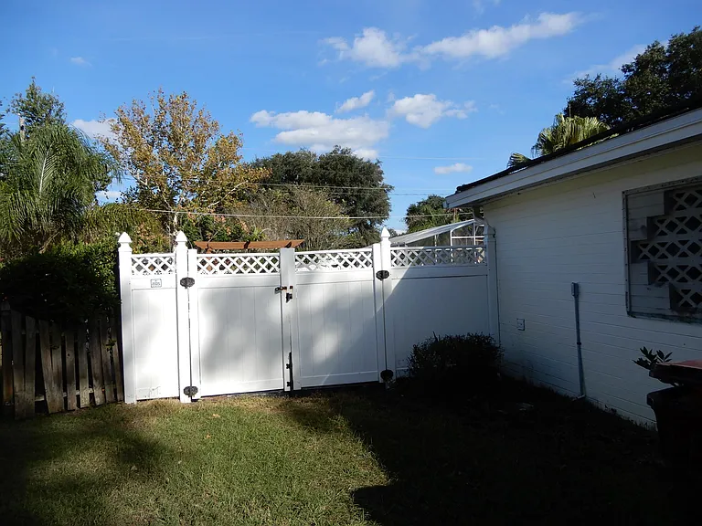 Large double fence gates for bringing large lawn equipment and other items into the backyard.
6 ft + PVC fence surrounds entire backyard for security and privacy.
