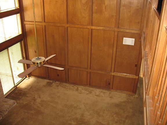 Large wood paneled den with great high ceilings.
