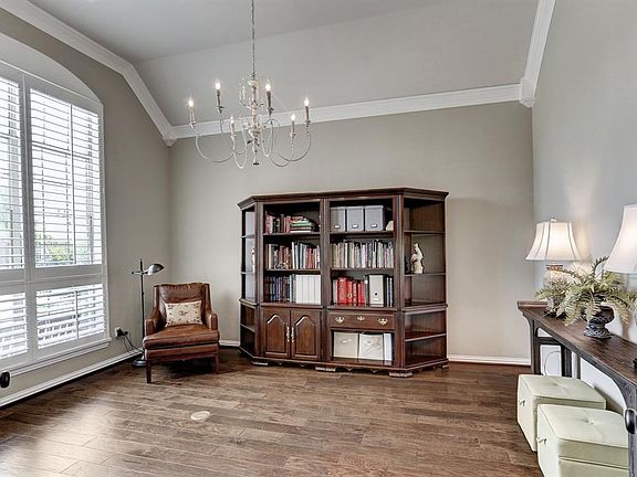 The study can be a large home office or formal living room. The high ceiling with crown molding and the large windows with plantation shutters make this a bright and elegant room.