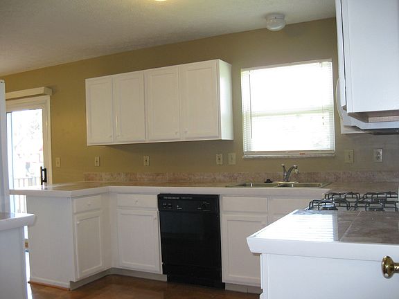 White cabinets, marble counters, and wood floors!
