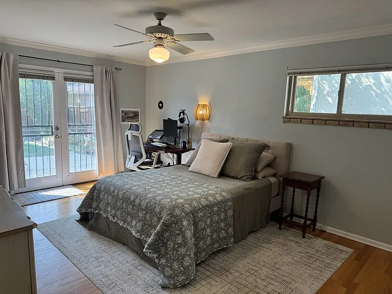 Large master bedroom for a house of this size. French doors lead to the patio.