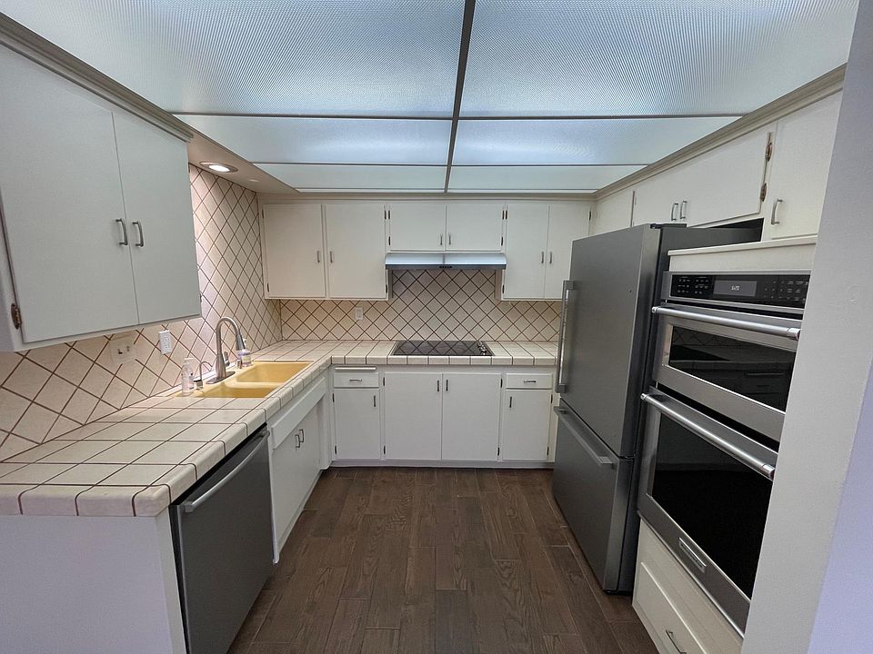 Newer stainless steel appliances with plenty of cabinets.