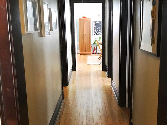 Hall between living room and dining room. Main bathroom & bedroom 1 & 2 are off of it.