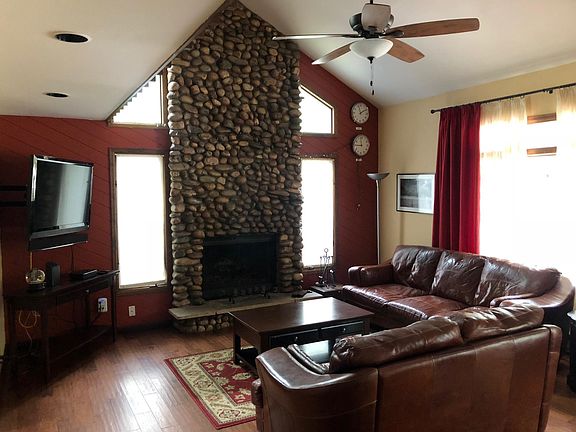 Living room area with wood-burning fireplace.