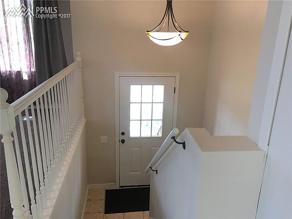 Front door with updated lighting and fresh paint.