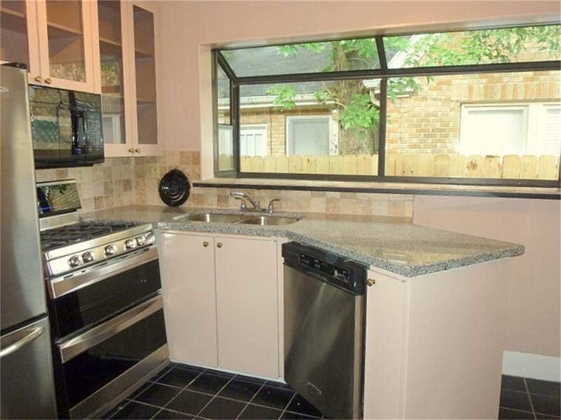 Recent appliances and newly installed granite counter tops and tile back splash.