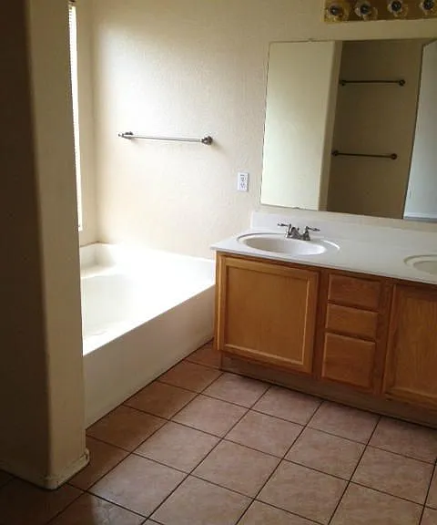 Master bathroom with bathtub, shower, separate toilet room.
