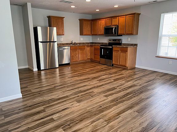 Kitchen in new stainless steel appliances. Fridge has an ice maker.