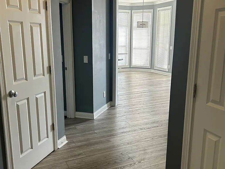 From Unit entrance hallway to the living area. Washer/Dryer behind the closer doors in hallway.