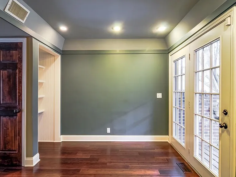 View from kitchen area with large window and door to private porch and patio on right