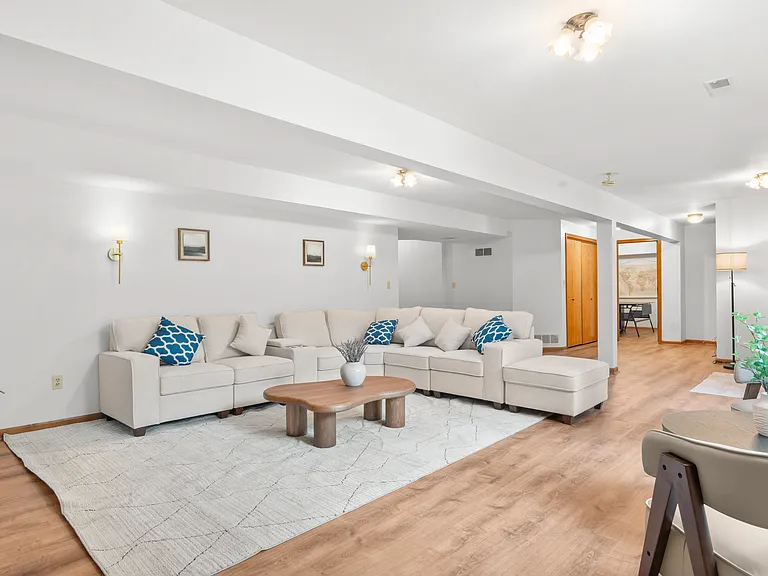 Spacious basement recreation lounge with generous seating and plenty of open space for relaxing, entertaining, or gathering with family and friends.