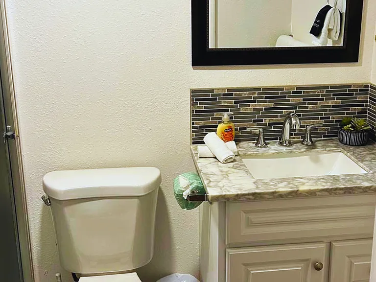 Spotless bathroom with fresh towels, soap, and thoughtful decor.