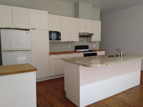 Kitchen includes dishwasher, gas stove, refrigerator, microwave, granite and woodblock counters as well as lots of cabinets and a pull out pantry. There is also a front loading washer and dryer in the apartment, not shown here.
