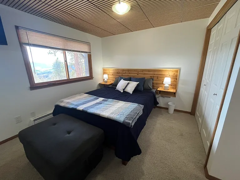 Bedroom with view to the mountains; custom headboard and night stands; and closet