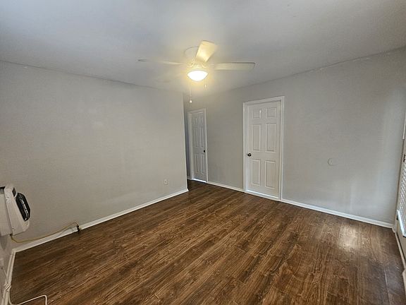 2nd view of the living room. The door leads to bedroom 1 that faces the front of the home.