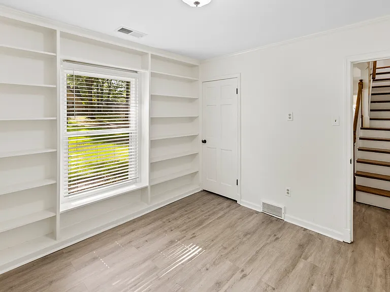 Bonus room with built-in shelving and natural light _ perfect as a reading nook, home office, or playroom.