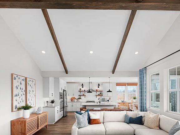 Great room with vaulted ceiling and stained ceiling beams