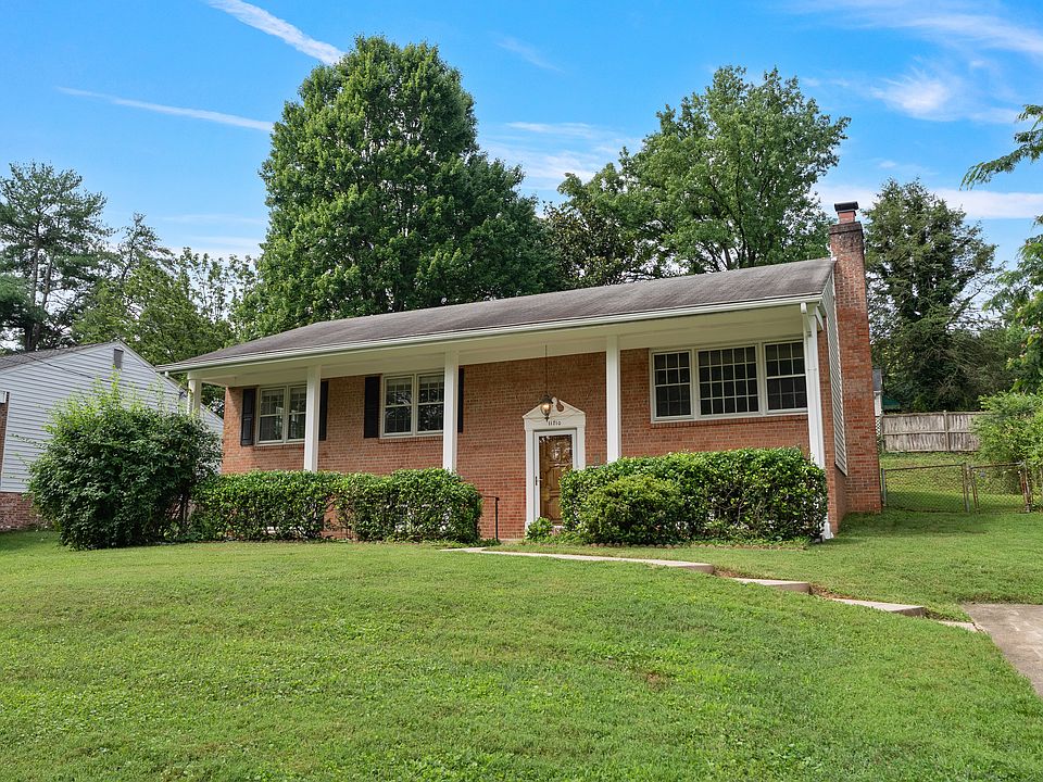 Front of house, driveway to the right.