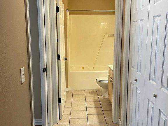 Hallway to bathroom 1 and bedroom 1 with hall storage closet