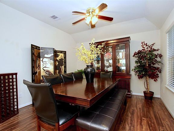 The Dining Room features high ceilings and gorgeous wood laminate floors.