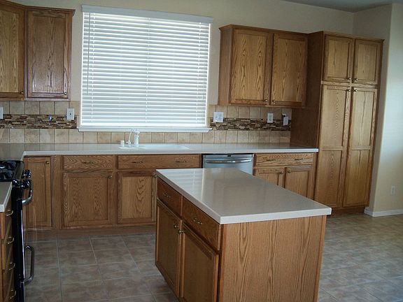 KITCHEN WITH NEW STAINLESS APPLIANCESAND GORGEOUS COUNTERS AND BACKSPLASH