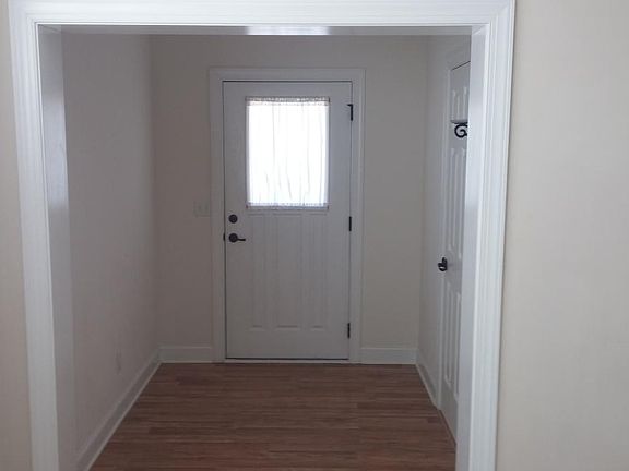Front door entry with half bath on left