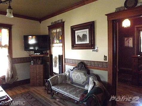 Large Living Room with Oak Flooring and Pocket Doors.