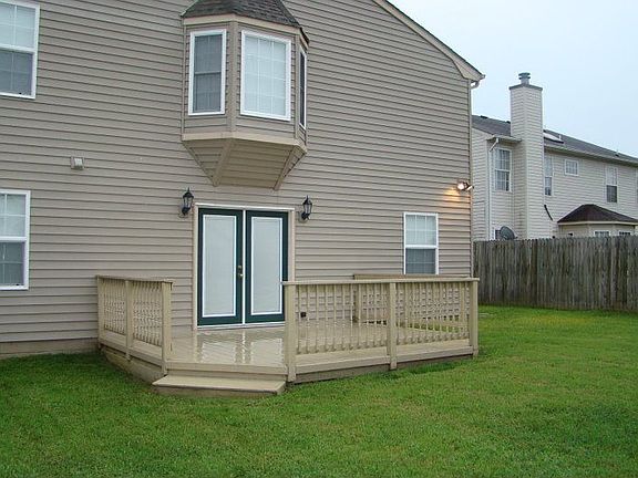 Fenced back yard with deck