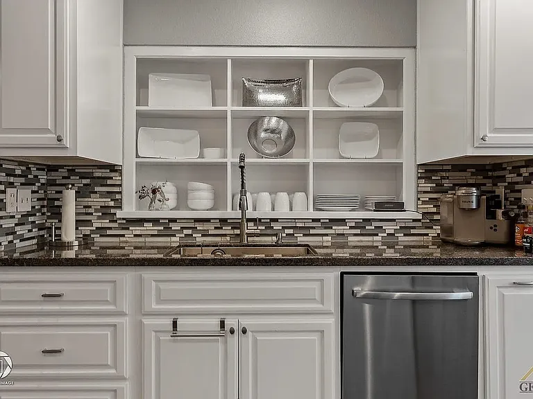 Kitchen sync with Insinkerator and dishwasher.