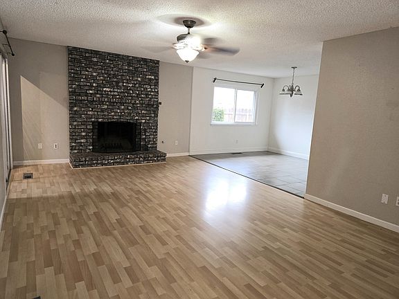 open concept living room with Fireplace, new flooring!