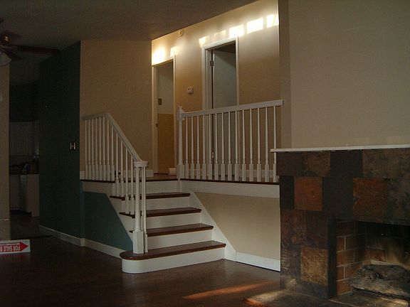 Living room w/ gas fireplace, bedrooms upstairs, hardwood floors throughout
