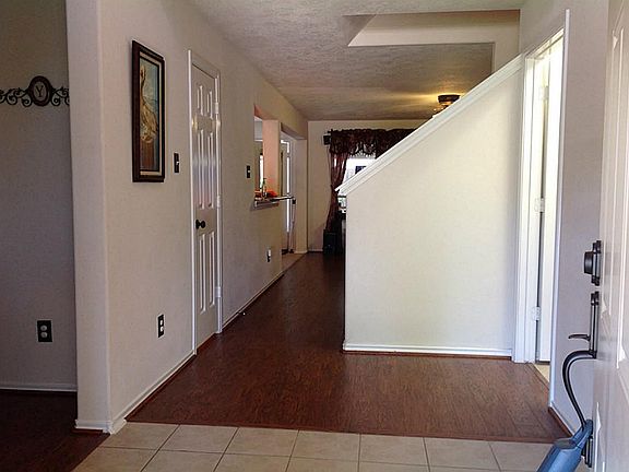 Past the entry is the beginning of the Living Room/Den area and that little door to the left is the 