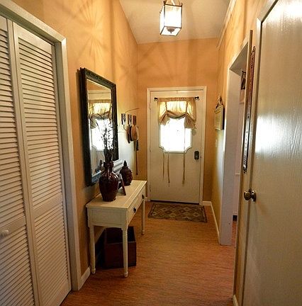 Foyer with new laminate flooring and coat closet.