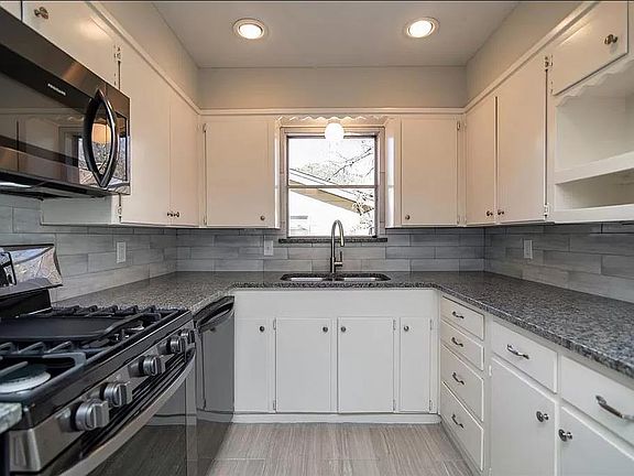 All new stainless steel appliances with granite countertops, backsplash, and new sink