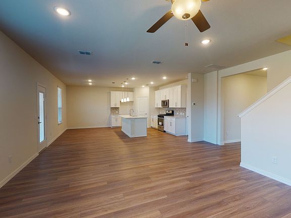 Open-concept gathering room with views of the kitchen