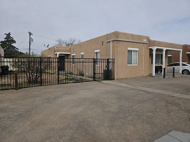 This image shows 217 (front) and entrance to (219) behind the gate.