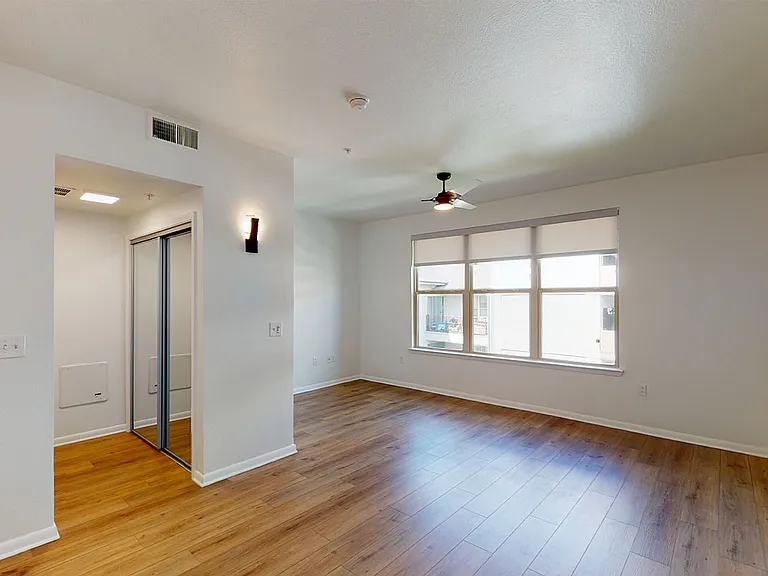 Apartment living room with wood-style flooring.