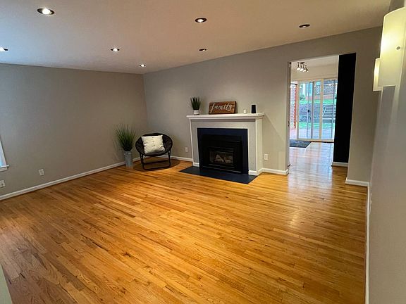 Gas fireplace and wood floors make this living room so cute and cozy!
