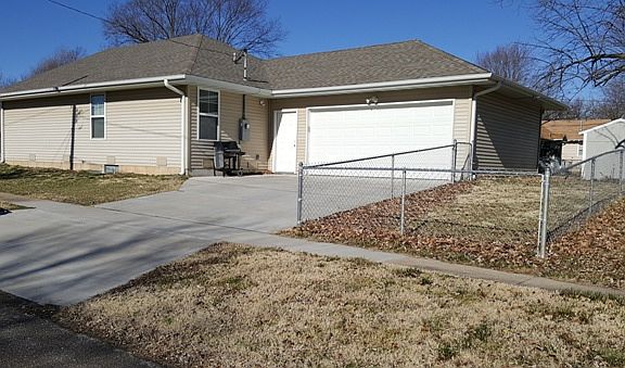 Two-car automatic garage and small, fenced backyard area