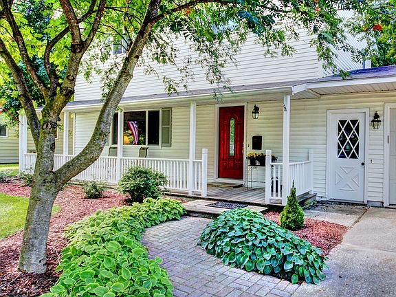 An inviting landscaped entrance and a home with tons of curb appeal greet visitors as you approach.