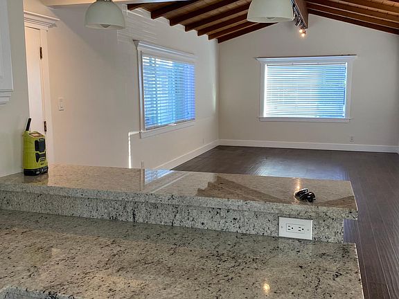 Open floor plan with bar and sink