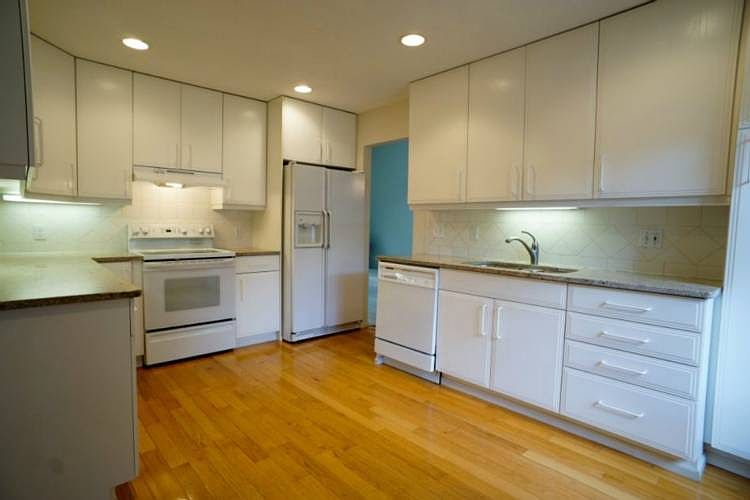 This is a fantastic kitchen.  Bright, cheery and well planned it also boasts granite counters, tile back splash, under cabinet lighting and beautiful wood floors.